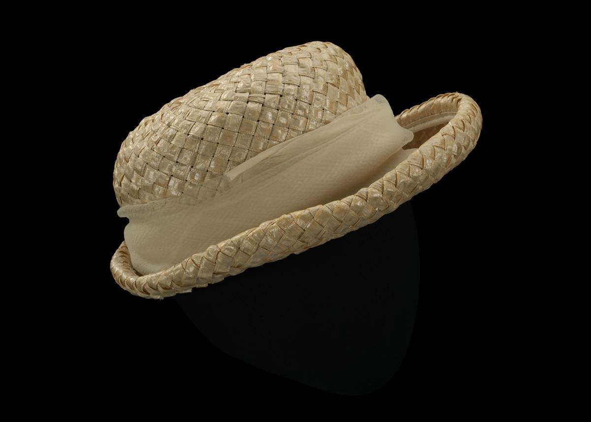Infographic comparing fabric types in designer hats: silk-lined vs. polyester vs. cotton, showing friction levels, breathability, and UV protection ratings