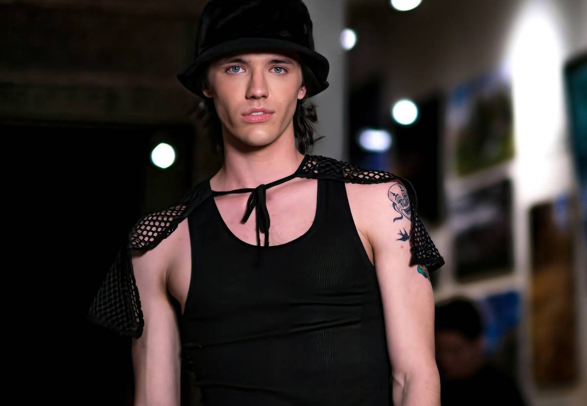 Woman wearing a sleek black vogue hat with satin interior lining